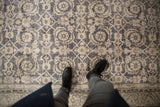 Distressed vintage Sparta carpet's Herati pattern, dusty navy, ivory, with visible foundation wear.