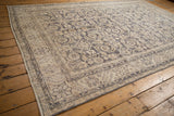 Distressed Turkish Sparta carpet, showing dusty navy Herati motif, ivory, and foundation wear.