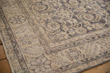 Distressed vintage Sparta rug corner: muted Herati pattern, serrated border, foundation showing.