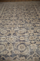 Texture of vintage distressed Sparta carpet, Herati motif, dusty navy, ivory, foundation showing.