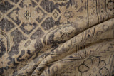 Folded vintage Sparta carpet with intricate Herati motif and vinery in distressed ivory and charcoal.