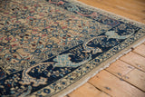 Vintage distressed Bijar rug's navy curvilinear border and beige Herati field.