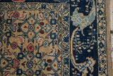 Distressed Bijar rug close-up: beige geometric Herati field and navy curvilinear border.