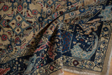 Navy blue curvilinear floral border with geometric Herati design on a distressed Bijar rug.