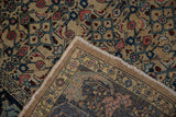 Distressed vintage Bijar rug corner displaying geometric Herati field and curvilinear floral border.