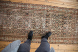 Distressed vintage Mahal runner with faded trellis pattern in charcoal, rust, and ivory.