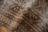 Distressed Mahal rug runner close-up, revealing worn trellis motif in madder root and ivory.