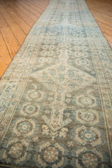 Distressed vintage Malayer runner's geometric Herati design in pale blue, charcoal, and beige.