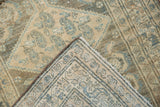 Distressed Malayer rug, folded corner revealing muted geometric pattern and foundation weave.