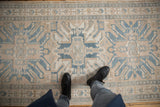 Distressed hand-knotted vintage Karaja runner showing geometric border, stylized eagle motifs in beige and blue.