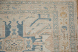Distressed Karaja runner corner with geometric patterns, visible knot heads in beige and blue.