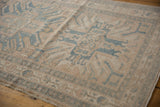 Textured pile of a distressed Karaja runner with geometric motifs, beige and denim blue.