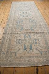 Distressed Karaja runner's geometric border, faint foundation, with soft beige and blue hues.