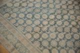 Distressed vintage Mahal rug's repeating floral and animal pattern in dusty blue and beige.