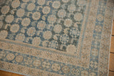Distressed vintage Mahal rug corner, showing blue floral field and intricate beige geometric borders.