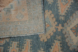 Distressed vintage Malayer rug reveals dusty blue pile, hand-knotted back, and selvage.