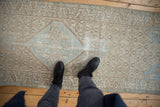 Distressed vintage Borchalou runner underfoot, showcasing faded beige and dusty blue Herati motif.