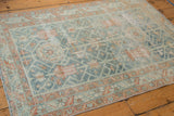 Distressed Malayer rug border with terracotta serrated leaves and softened dusty blue pile.