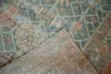 Vintage distressed Malayer rug showing hand-knotted backing and worn pile in dusty blue, terracotta, ivory.