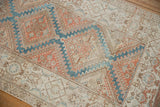 Close-up of distressed Malayer runner, showing pale terracotta, sky blue, and ivory Herati motifs.