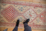A point-of-view shot of a distressed Serab runner's geometric medallion and low pile texture.