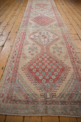 Lengthwise view of a distressed Serab runner highlighting its column of geometric medallions.
