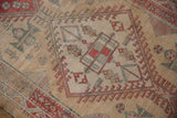 Faded geometric medallion with pinwheel motifs on the low-pile surface of a distressed Serab runner.