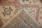 Folded corner of a Serab runner shows its hand-knotted back and geometric low-pile face.