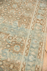 Distressed vintage Hamadan rug pile showcasing beige and powder blue Herati motif and border.