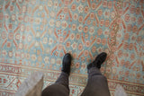 A personal view of the distressed texture and floral pinwheels on a powder blue Malayer rug.