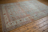 Angled view of a distressed Malayer carpet, highlighting the abrashed powder blue ground.
