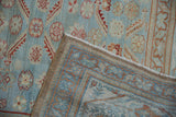 Folded corner of a vintage Malayer rug revealing its hand-knotted back and secured selvage.