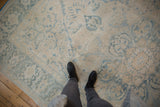 Distressed vintage Persian Ahar carpet, ivory and pale blue floral motifs, even wear.