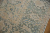 Distressed Ahar vintage carpet showing worn ivory and blue curvilinear floral patterns.