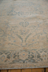 Distressed texture and softened ivory, dusty blue tones of the Ahar carpet border.