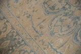 Distressed Ahar rug's ivory and pale blue curvilinear floral pattern with soft, even pile wear.