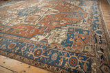 Antique Serapi carpet's preserved side cord selvage and intricate terracotta, navy borders.