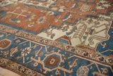 Terracotta field with sapphire blue border, highlighting intricate blossoms and serrated leaves.