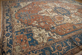 Terracotta and navy geometric motifs with stylized leaves and blossoms on an antique Serapi carpet.