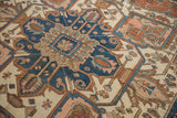 Antique Serapi carpet's palmette finial design in navy, terracotta, and ivory.