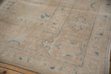 Distressed Vintage Sivas carpet: sand field, sky blue motifs, even wear, intact side selvage.