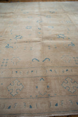 Vintage Distressed Sivas carpet: worn sand field, faint foundation, sky blue floral motifs.