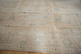 Distressed vintage Sivas carpet showing faded sky blue motifs and textured pile.