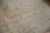 Distressed vintage Sivas carpet showing worn sand pile and faded sky blue motifs.