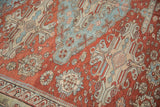 Antique Soumac carpet detail: distressed geometric floral field motifs, wave border in softened red and pale blue.