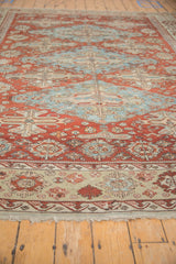 Distressed antique Soumac carpet border with red palmettes, wave motif, and visible fringe.