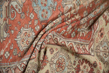 Distressed texture of folded antique Caucasian Soumac carpet, showing geometric floral motifs.