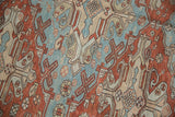 Distressed antique Soumac carpet, tribal geometric motifs in black cherry red, pale blue.