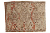 Distressed vintage Caucasian Soumac rug with oxidized silver, brick red floral medallions.