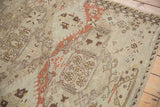 Distressed Soumac rug texture and floral cross-sections in platinum and brick red.